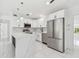 Modern white kitchen with stainless steel appliances, and marble countertops at 1600 Delaware Ne Ave, St Petersburg, FL 33703