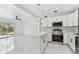Open kitchen with modern appliances, quartz countertops, island, and sliding doors to deck at 1600 Delaware Ne Ave, St Petersburg, FL 33703