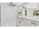 Open kitchen with white cabinetry, a marble island, and stainless steel appliances at 1600 Delaware Ne Ave, St Petersburg, FL 33703
