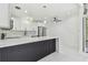 Open-concept kitchen with white quartz countertops, island with seating, and stainless steel appliances at 1600 Delaware Ne Ave, St Petersburg, FL 33703