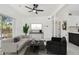 Bright living room featuring modern furniture, white tile floors, and natural light at 1600 Delaware Ne Ave, St Petersburg, FL 33703