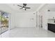 Open living area with tile flooring, ceiling fan, and sliding doors to a deck at 1600 Delaware Ne Ave, St Petersburg, FL 33703