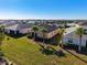 Aerial view of backyards showing enclosed lanai, tropical palm trees, healthy landscaping and community lake at 17533 Timberline Pkwy, Punta Gorda, FL 33982