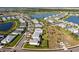 Expansive aerial view of a Primary-planned community featuring homes, a lake, and recreation areas at 17533 Timberline Pkwy, Punta Gorda, FL 33982