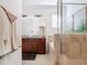 View of a bathroom with a double vanity, granite countertop, tub, tiled shower, and decorative towels at 17533 Timberline Pkwy, Punta Gorda, FL 33982