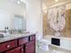 Bathroom featuring granite countertops, tiled shower and a tub with a shower curtain at 17533 Timberline Pkwy, Punta Gorda, FL 33982