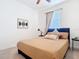 Bedroom features a neatly made bed with neutral bedding and minimalistic decor at 17533 Timberline Pkwy, Punta Gorda, FL 33982