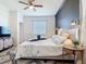 Cozy bedroom with ceiling fan, side table, modern lighting, and decorative bedspread at 17533 Timberline Pkwy, Punta Gorda, FL 33982