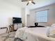 Inviting bedroom with large TV, dresser, ceiling fan, and stylish accents at 17533 Timberline Pkwy, Punta Gorda, FL 33982