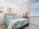Bright bedroom with patterned bedding and decorative side table with lamps at 17533 Timberline Pkwy, Punta Gorda, FL 33982
