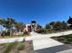 Modern community center framed by palm trees and greenery at 17533 Timberline Pkwy, Punta Gorda, FL 33982