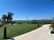Scenic view overlooking the lake and community from the turfed lawn with a walkway on the right at 17533 Timberline Pkwy, Punta Gorda, FL 33982