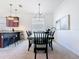 Dining room features a chandelier, a dark wood table with seating for six, and adjacent counter seating at 17533 Timberline Pkwy, Punta Gorda, FL 33982