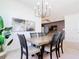 Open-concept dining area with modern chandelier lighting and views to the other living spaces at 17533 Timberline Pkwy, Punta Gorda, FL 33982