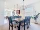 Open dining room with a dark wood table, seating for six, and view of the adjacent living areas at 17533 Timberline Pkwy, Punta Gorda, FL 33982
