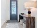 Welcoming foyer featuring a decorative door, stylish console table with lamp, and patterned rug creating a warm ambiance at 17533 Timberline Pkwy, Punta Gorda, FL 33982