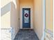 Inviting front entrance featuring a stylish door with glass panels and a decorative wreath, framed by brick accents at 17533 Timberline Pkwy, Punta Gorda, FL 33982