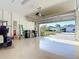 Spacious garage with a glimpse of the neighborhood through the open door and a golf cart on the side at 17533 Timberline Pkwy, Punta Gorda, FL 33982
