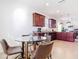 Eat-in kitchen with a glass table, seating for four, stainless steel appliances, and ample cabinets at 17533 Timberline Pkwy, Punta Gorda, FL 33982