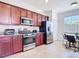 Modern kitchen with stainless steel appliances, granite countertops, and beautiful wood cabinets providing ample storage at 17533 Timberline Pkwy, Punta Gorda, FL 33982