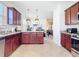 Well-equipped kitchen with stainless steel appliances, granite countertops, and view to the adjacent dining area at 17533 Timberline Pkwy, Punta Gorda, FL 33982