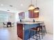 Bright kitchen with granite countertops, stainless steel appliances, and stylish bar seating with pendant lighting at 17533 Timberline Pkwy, Punta Gorda, FL 33982