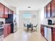 Well-lit kitchen with stainless steel appliances, wood cabinets, granite counters, and a breakfast nook with lots of natural light at 17533 Timberline Pkwy, Punta Gorda, FL 33982