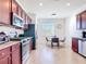 Spacious kitchen with stainless steel appliances, granite countertops, and an adjacent dining area with lots of natural light at 17533 Timberline Pkwy, Punta Gorda, FL 33982