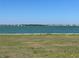 Scenic lake view showcasing waterfront homes and buildings against a clear sky, enhancing the tranquil setting at 17533 Timberline Pkwy, Punta Gorda, FL 33982
