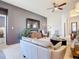 Comfortable living room with a large flat screen TV, ceiling fan, and modern furniture at 17533 Timberline Pkwy, Punta Gorda, FL 33982