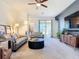 Comfortable living room with plush sofas, modern decor, ceiling fan, and sliding glass doors to the lanai at 17533 Timberline Pkwy, Punta Gorda, FL 33982