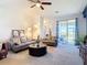 Bright living room featuring comfortable leather sofas, contemporary decor, and sliding glass doors to the outdoor area at 17533 Timberline Pkwy, Punta Gorda, FL 33982