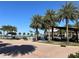 Relaxing outdoor seating area with shady structures and palm trees, perfect for community gatherings and dining at 17533 Timberline Pkwy, Punta Gorda, FL 33982