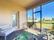 Enclosed outdoor patio with door and view of the back yard at 17533 Timberline Pkwy, Punta Gorda, FL 33982
