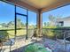 Enclosed patio providing a bug-free relaxing spot with a view of the grassy lawn and lush green hedges at 17533 Timberline Pkwy, Punta Gorda, FL 33982