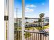 Balcony view overlooking a coastal neighborhood, with a waterfront view beyond at 187 145Th E Ave # 4, Madeira Beach, FL 33708