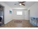 Bright bedroom featuring hardwood flooring, a ceiling fan, and a window, complemented by a stylish table at 1902 Andover St # 198, Sun City Center, FL 33573