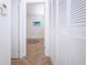 Bright hallway with wood tile flooring, storage closet and access to the bedrooms at 1902 Andover St # 198, Sun City Center, FL 33573