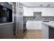 Contemporary kitchen with stainless steel refrigerator, quartz countertops, and herringbone floors at 1902 Andover St # 198, Sun City Center, FL 33573
