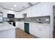Contemporary kitchen boasting white cabinetry, stainless steel appliances, and a gray subway tile backsplash at 1902 Andover St # 198, Sun City Center, FL 33573