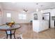 Open-concept space featuring a modern kitchen island, dining area, and comfortable seating, perfect for gatherings at 1902 Andover St # 198, Sun City Center, FL 33573