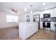 Open-concept living room and kitchen area with modern finishes and bright lighting at 1902 Andover St # 198, Sun City Center, FL 33573