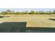 Well-maintained backyard featuring a large grassy area with pond views and mature landscaping at 2335 E Del Webb Blvd, Sun City Center, FL 33573