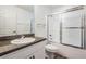Bathroom with a vanity, granite counters, and a shower over tub with sliding glass doors at 2335 E Del Webb Blvd, Sun City Center, FL 33573