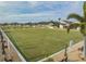 Beautiful bowling green surrounded by benches and palm trees at 2335 E Del Webb Blvd, Sun City Center, FL 33573