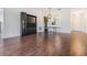 Bright dining room with wood floors features a modern light fixture and decorative window at 2335 E Del Webb Blvd, Sun City Center, FL 33573