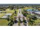 Aerial view of gated community entrance featuring lush landscaping and access to community amenities at 2335 E Del Webb Blvd, Sun City Center, FL 33573