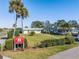 Well-maintained single-story home with a lush green lawn and mature landscaping at 2335 E Del Webb Blvd, Sun City Center, FL 33573