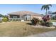 Charming front exterior with landscaped yard, screened porch, and attached two-car garage at 2335 E Del Webb Blvd, Sun City Center, FL 33573