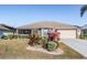 Charming single-story home features a manicured lawn, mature landscaping, and a two-car garage at 2335 E Del Webb Blvd, Sun City Center, FL 33573